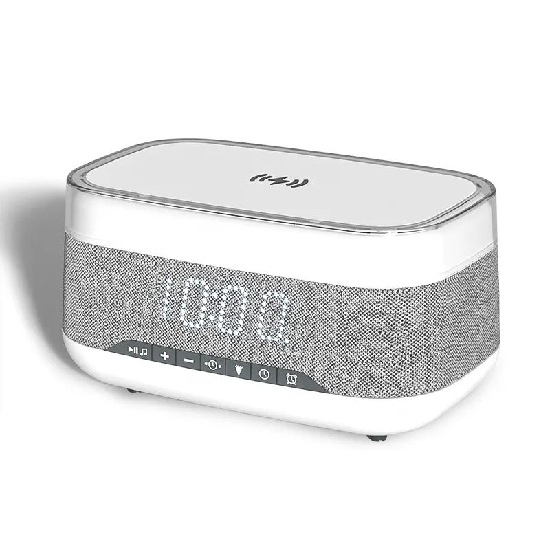 a white speaker with a clock on it. The speaker is sitting on a white background. The clock is located on the top of the speaker and has a black digital display. The speaker has a black base and two black speakers on either side. 